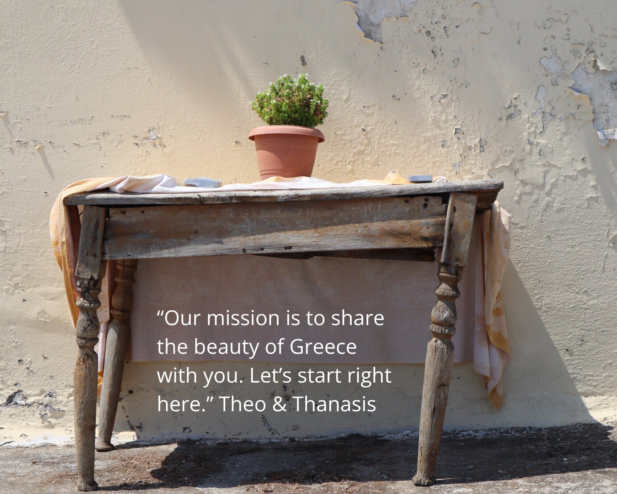 “Our mission is to share the beauty of Greece with you. Let’s start right here.” - a rustic table and potted plant in the Greek sun, Monobrow Holidays Greece